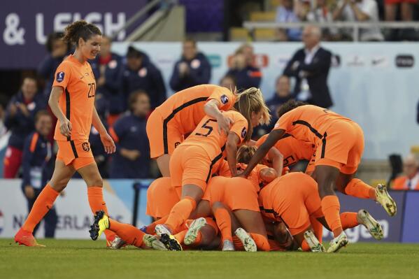 Netherlands' players celebrate their side's third goal, scored by Danielle van de Donk during the Women Euro 2022, group C, soccer match between Netherlands and Portugal, at Leigh Sports Village, in Wigan & Leigh, England, Wednesday, July 13, 2022. (AP Photo/Jon Super)