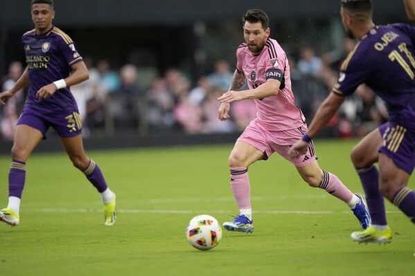 Inter Miami forward Lionel Messi (10) dribbles the ball under pressure from Orlando City midfielder Mart铆n Ojeda (11) and Orlando City defender Rafael Santos (3) during the first half of an MLS soccer match, Saturday, March 2, 2024, in Fort Lauderdale, Fla. (APPhoto/Rebecca Blackwell)