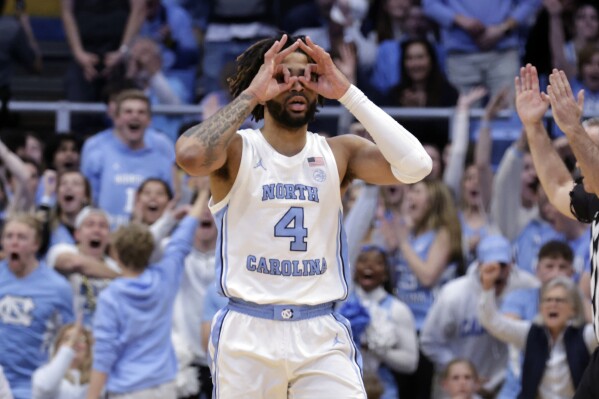 North Carolina guard RJ Davis (4) celebrates after shooting a 3-point basket against Miami during the second half of an NCAA college basketball game Monday, Feb. 26, 2024, in Chapel Hill, N.C. (AP Photo/Chris Seward)