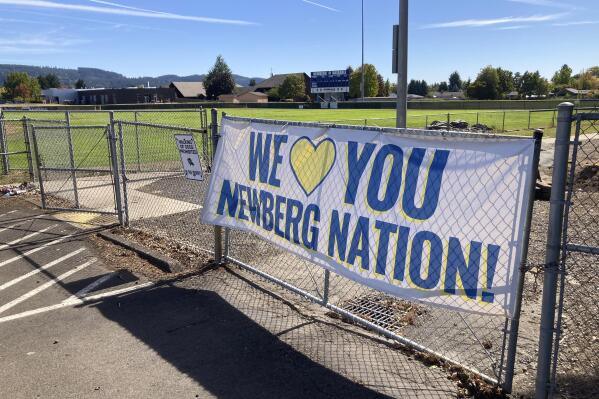 FILE - A banner thanking supporters of Newberg schools is seen on Sept. 21, 2021, next to the athletic fields of Newberg High School, in Newberg, Ore. The Newberg School Board has rescinded its policy banning educators from displaying Black Lives Matter and gay pride symbols following a court settlement with a teachers union after the town became an unlikely focal point of a battle between the left and right across the nation over schooling. (AP Photo/Andrew Selsky, File)