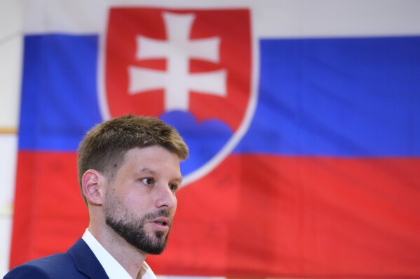 Leader of Progressive Slovakia party Michal Simecka prepares to cast his vote at a polling station during an early parliamentary election in Bratislava, Slovakia, Saturday, Sept. 30, 2023. (AP Photo/Petr David Josek)
