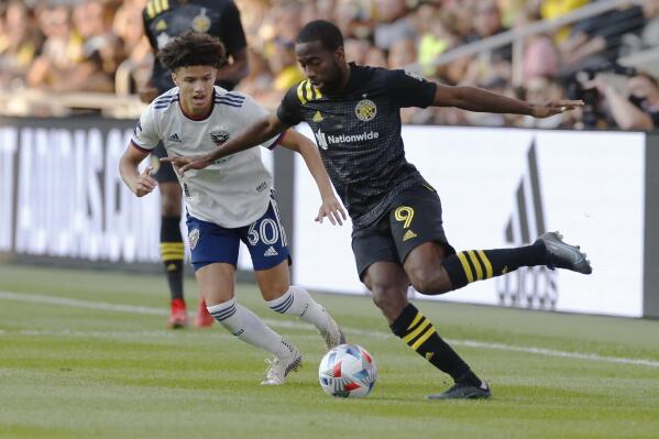Columbus Crew's Kevin Molino, right, dribbles the ball next to D.C. United's Kevin Paredes during the first half of an MLS soccer match Wednesday, Aug. 4, 2021, in Columbus, Ohio. (AP Photo/Jay LaPrete)