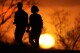 FILE - A couple walks through a park at sunset, March 10, 2021, in Kansas City, Mo. U.S. life expectancy rose in 2022 鈥� by more than a year 鈥� after plunging two straight years at the beginning of the COVID-19 pandemic, according to a new government report released Wednesday, Nov. 29, 2023. The rise was mainly due to the waning of the pandemic in 2022, researchers said at the Centers for Disease Control and Prevention. (AP Photo/Charlie Riedel, File)