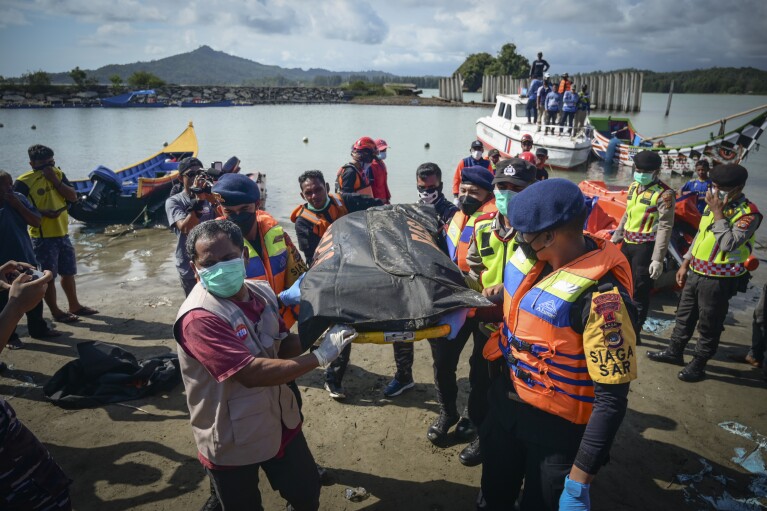 Rescuers carry the body of a Rohingya refugee recovered from the sea off Meulaboh, Indonesia, on Saturday, March 23, 2024. The bodies of 12 women and three children were recovered following the capsize of a boat that was carrying around 140 Rohingya refugees, according to the United Nations High Commissioner for Refugees. Sixty-seven people were killed in the disaster. (AP Photo/Reza Saifullah)