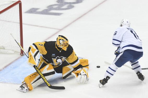 Right wing Mitchell Marner scores on Pittsburgh Penguins goalie Casey DeSmith during the first period of a hockey game, Saturday, Nov. 26, 2022, in Pittsburgh. (AP Photo/Philip G. Pavely)