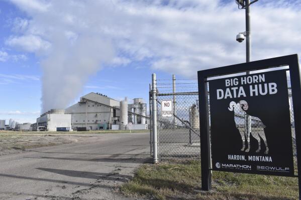 The Hardin Generating Station, a coal-fired power plant that is also home to the cryptocurrency "mining" operation Big Horn Data Hub, is seen on April 20, 2022, in Hardin, Mont. Energy from burning coal is used to power thousands of computers that are kept on site to produce the digital currency known as bitcoins. (AP Photo/Matthew Brown)