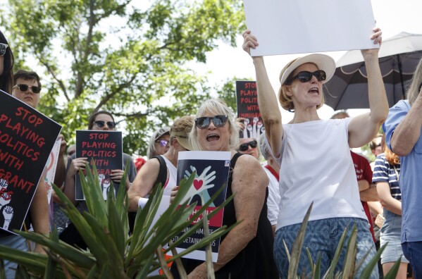 FILE - People at the Keep Families Together rally as the son of Holocaust survivors speaks about the importance of offering asylum in the South Plaza of the Oklahoma State Capitol Building in Oklahoma City, Okla. on Saturday, June 30, 2017. (Anya Magnuson/The Oklahoman via AP, File)