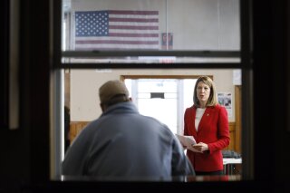 FILE - In this Nov. 11, 2019, file photo, Rep. Cindy Axne, D-Iowa, speaks to local residents at the American Legion Post 184 in Winterset, Iowa. Few states have changed politically with the head-snapping speed of Iowa. (AP Photo/Charlie Neibergall, File)