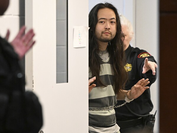 Maximilian Snyder, who is charged with allegedly killing an 82-year-old Vallejo landlord to prevent him from testifying in a murder case against his former tenants, walks into court with his hands up for arraignment Thursday, Feb 6, 2025, in Fairfield, Calf. (Chris Riley, Times-Herald via AP)/The Times-Herald via AP)