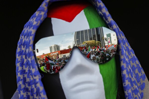 Hundreds of protesters demonstrate in support of Palestinians calling for a ceasefire in Gaza near the Dolby Theatre where the 96th Academy Awards Oscars ceremony is held on Sunday, March 10, 2024, in the Hollywood section of Los Angeles. (AP Photo/Etienne Laurent)