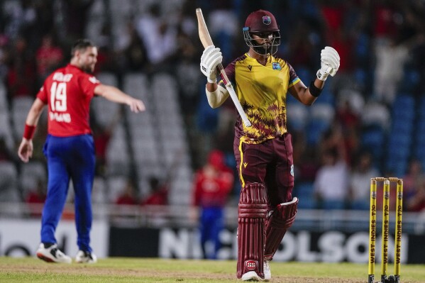 West Indies' Shai Hope celebrates hitting a six from a delivery of England's Chris Woakes to win by 4 wickets the fifth T20 cricket match at Brian Lara Stadium in Tarouba, Trinidad and Tobago, Thursday, Dec. 21, 2023. (AP Photo/Ricardo Mazalan)