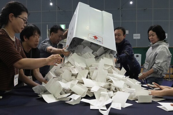 National Election Commission officials sort ballots for counting during the presidential election in Seoul, South Korea, Tuesday, June 3, 2025. (AP Photo/Ahn Young-joon)