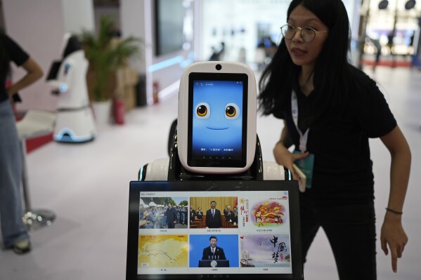 A robot receptionist with a screen showing Chinese President Xi Jinping is displayed at the annual World Robot Conference at the Beijing Etrong International Exhibition and Convention Center, Wednesday, Aug. 16, 2023. (AP Photo/Ng Han Guan)