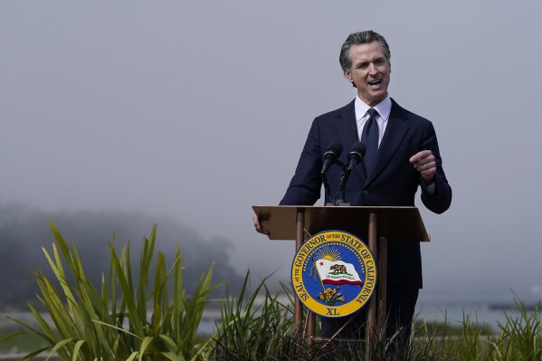 California Gov. Gavin Newsom speaks at the Presidio Tunnel Tops before the signing of a new climate agreement in San Francisco on Oct. 6, 2022. California, a state known for its ambitious climate policies, could soon adopt new laws reducing emissions from buildings, easing the burden on taxpayers to clean up abandoned oil and gas wells, and requiring the most sweeping emissions reporting mandates for large companies in the nation. They are among the hundreds of bills lawmakers sent to Newsom's desk this year. (AP Photo/Jeff Chiu, File)