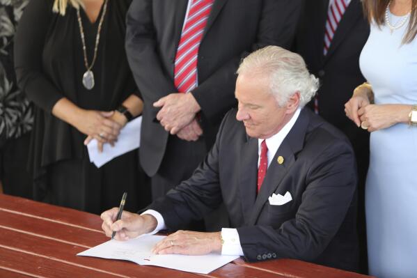South Carolina Gov. Henry McMaster signs a bill preventing people from suing businesses over COVID-19 on Thursday, June 24, 2021 at Cafe Strudel in West Columbia, South Carolina. The bill signing was ceremonial after the General Assembly passed the legislation in April. (AP Photo/Jeffrey Collins)