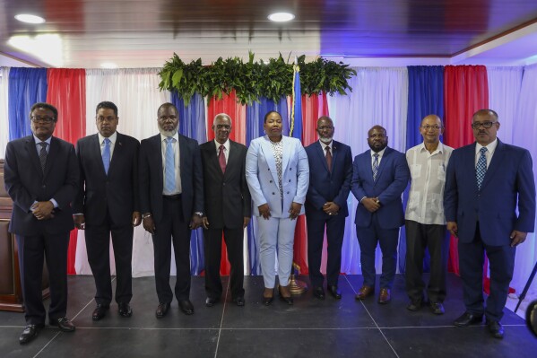 IDENTIFIES TRANSITIONAL COUNCIL MEMBERS - Transitional Council members, from left to right; Fritz Alphonse Jean, Laurent Saint-Cyr, Frinel Joseph, Edgard Leblanc Fils, Regine Abraham, Emmanuel Vertilaire, Smith Augustin, Leslie Voltaire and Louis Gerald Gilles, pose for a group photo after a ceremony to name its president and a prime minister in Port-au-Prince, Haiti, Tuesday, April 30, 2024. Fils was chosen as the president of the panel. (AP Photo/Odelyn Joseph)