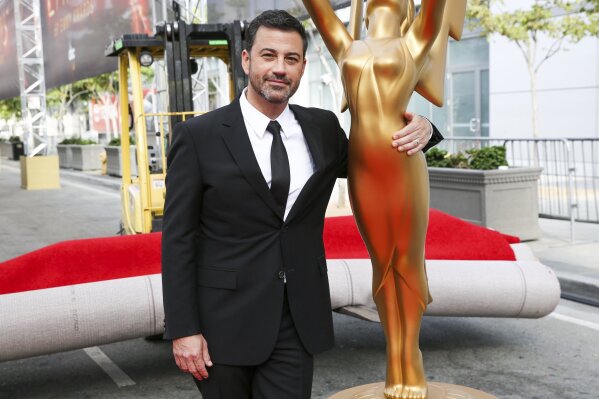 FILE - This Sept. 14, 2016 file photo shows host Jimmy Kimmel posing for a photo with a replica of an Emmy statue at the Primetime Emmy Awards Press Preview Day in Los Angeles. Kimmel will return as host and will serve as executive producer for the 72nd Emmy Awards. The show will be broadcast, Sunday, Sept. 20, on ABC. (Photo by Rich Fury/Invision/AP, File)