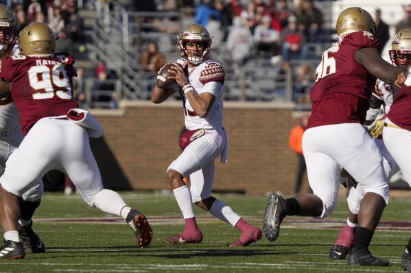 Florida State quarterback Jordan Travis (13) looks to pass during the first half of an NCAA college football game against Boston College, Saturday, Nov. 20, 2021, in Boston. (AP Photo/Mary Schwalm)