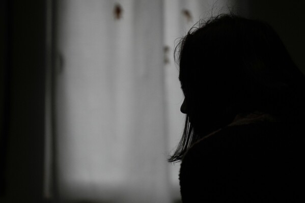 A 26-year-old woman, who wouldn't give her name for security reasons speaks in safe house for women in Belgrade, Serbia, Thursday, Nov. 23, 2023. She said her partner repeatedly raped her, beat and choked her, and kept her and the baby locked in their flat for hours at a time. Throughout the Western Balkans, women are harassed, raped, beaten and killed, often by their partners and after repeatedly reporting the violence to the authorities. (AP Photo/Darko Vojinovic)