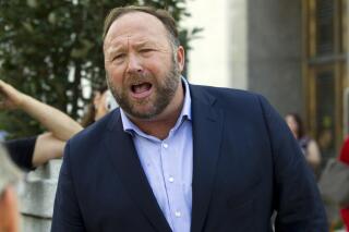 FILE— Alex Jones, "infowars" host, speaks outside of the Dirksen building of Capitol Hill in Washington, Sept. 5, 2018. Jones defied a Connecticut judge's order to show up for a deposition in Texas, Thursday, March 24, 2022, in a case brought by relatives of victims of the Sandy Hook Elementary School shooting who sued Jones for calling the massacre a hoax, according to the families' lawyer. (AP Photo/Jose Luis Magana, File)