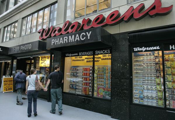 FILE - Window shoppers look at a Walgreens storefront in San Francisco on June 26, 2006. A federal judge ruled Wednesday, Aug. 10, 2022, that the pharmacy chain Walgreens can be held responsible for contributing to San Francisco's opioid crisis for over-dispensing opioids for years without proper oversight and failing to identify and report suspicious orders as required by law. (AP Photo/Ben Margot, File)