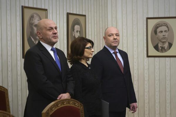 Nikolay Gabrovski, right, the prime-minister-designate from the largest group in Parliament - the center-right GERB-UDF coalition looks on before receiving the mandate to form a government at the Bulgarian Presidency, along with GERB party parliamentary leader Dessislava Atanasova, center, and Tomislav Donchev, in Sofia, Monday, Dec. 5, 2022. Accepting the mandate, Gabrovski said he will propose a cabinet "that is farther from political talk, from confrontation and closer to professionalism", and able to deal with the multiple crises the country is facing now. (AP Photo/Valentina Petrova)