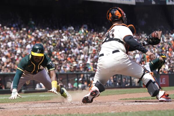 San Francisco Giants' Buster Posey scores against the Los Angeles