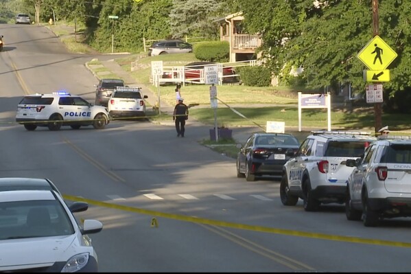Police investigate the area of a shooting Saturday evening in Madisonville neighborhood in Cincinnati on Sunday, June 16, 2024. Five people were shot during a community day celebration but none of the injuries were considered life-threatening, police say. (WCPO via AP)