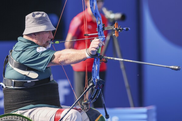 Shaun Anderson of South Africa competes during the men's individual W1 quarter final para archery competition of the Paris 2024 Paralympic Games at Invalides, in Paris, Sunday Sept. 1, 2024. (Roger Sedres/Team South Africa via AP)