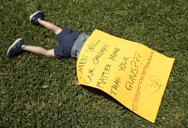 Remy Ragsdale, 3, attends a protest organized by Moms Demand Action on Wednesday May 25, 2022, at the Governor's Mansion in Austin, Texas, after a mass shooting at an elementary school in Uvalde. (Jay Janner/Austin American-Statesman via AP)