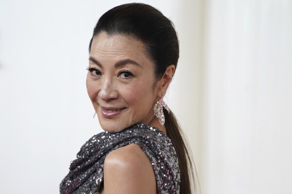 FILE - Michelle Yeoh arrives at the Oscars on Sunday, March 10, 2024, at the Dolby Theatre in Los Angeles. Oscar winner Michelle Yeoh, Botswana President Mokgweetsi Masisi, and Verizon CEO Hans Vestberg are among the diverse group of political, business and philanthropic leaders Global Citizen will convene in New York on May 1 and 2, the nonprofit announced on Thursday, March 28, 2024.(Photo by Jordan Strauss/Invision/AP, File)