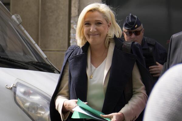 FILE - French far-right candidate Marine Le Pen leaves her campaign headquarters in Paris, Monday, April 11, 2022. French President Emmanuel Macron, the incumbent president with strong pro-European views, and Marine Le Pen, an anti-immigration nationalist, couldn't have more radically opposed visions of the EU. A win for far-right candidate Marine Le Pen in France's presidential race would have immense repercussions on the functioning of the European Union. (AP Photo/Francois Mori, File)