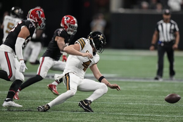New Orleans Saints quarterback Derek Carr (4) fumbles the ball against the Atlanta Falcons during the second half of an NFL football game, Sunday, Nov. 26, 2023, in Atlanta. (AP Photo/Brynn Anderson)