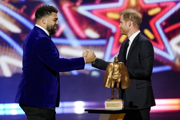 Britain's Prince Harry presents the Walter Payton Man of the Year Award to Pittsburgh Steelers' Cameron Heyward during the NFL Honors award show ahead of the Super Bowl 58 football game Thursday, Feb. 8, 2024, in Las Vegas. The San Francisco 49ers face the Kansas City Chiefs in Super Bowl 58 on Sunday. (AP Photo/David J. Phillip)