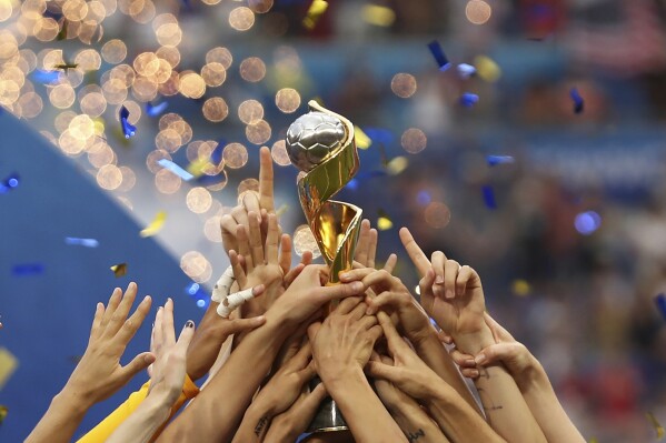 FILE - The United States players hold the trophy as they celebrate winning the Women's World Cup final soccer match against The Netherlands at the Stade de Lyon in Decines, outside Lyon, France on July 17, 2019. More prize money than ever will be awarded at this year's Women's World Cup, and the players stand to get direct payments from FIFA this time. (AP Photo/Francisco Seco, File)