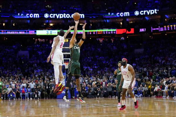 Boston Celtics' Jayson Tatum (0) goes up for the go-ahead shot against Philadelphia 76ers' De'Anthony Melton (8) during the final seconds of an NBA basketball game, Saturday, Feb. 25, 2023, in Philadelphia. (AP Photo/Matt Slocum)