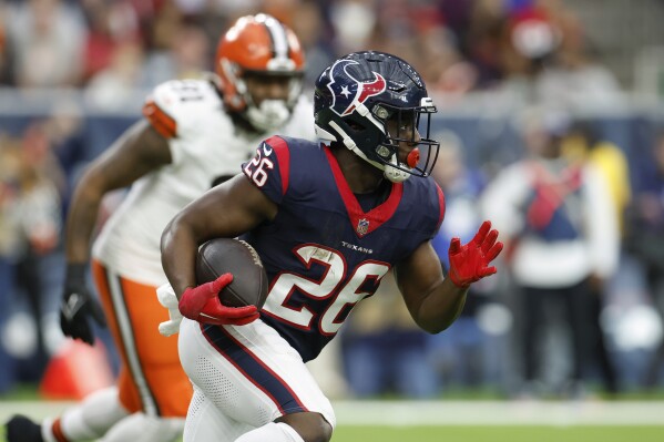 FILE - Houston Texans running back Devin Singletary carries the ball during an NFL wild-card playoff football game against the Cleveland Browns, Jan. 13, 2024, in Houston. On a day the New York Giants lost star running back Saquon Barkley in free agency, general manager Joe Schoen found a replacement and bolstered his team's weak offensive line Monday, March 11, by agreeing to terms with halfback Devin Singletary and guard Jon Runyan Jr. (AP Photo/Matt Patterson, File)