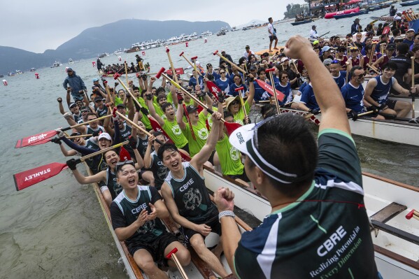 Competitors cheer before the race in the Stanley International Dragon Boat Championships to celebrate the Dragon Boat Festival in Hong Kong, Saturday, May 31, 2025. (AP Photo/Chan Long Hei)
