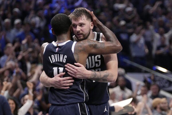 Dallas Mavericks' Kyrie Irving (11) and Luka Doncic, right, celebrate the team's win in Game 3 of an NBA basketball second-round playoff series against the Oklahoma City Thunder, Saturday, May 11, 2024, in Dallas. (AP Photo/Tony Gutierrez)
