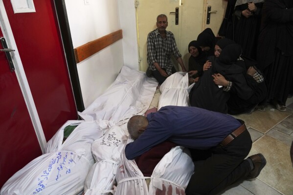 Palestinians mourn their relatives killed in an Israeli airstrikes in Jabalia, northern Gaza Strip, on Wednesday, May 14, 2025. According to local hospitals, 48 people were killed in the strikes, including 22 children. (AP Photo/Jehad Alshrafi)