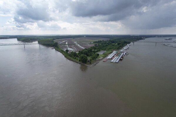 The confluence of the Mississippi River, left, and Ohio River, right, is visible Thursday, May 23, 2024, in Cairo, Ill. Devastating flooding, driven in part by climate change, is taking an especially damaging toll on communities that once thrived along the banks of the Mississippi River. (AP Photo/Jeff Roberson)