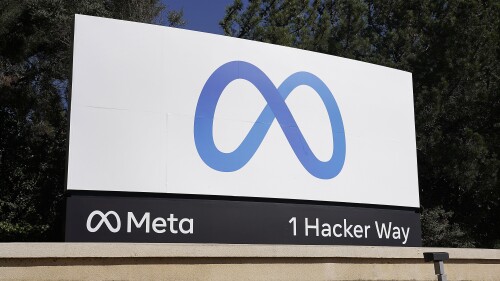 FILE - Facebook's Meta logo sign is seen at the company headquarters in Menlo Park, Calif. on Oct. 28, 2021. Meta CEO Mark Zuckerberg said Tuesday, July 18, 2023, the company is partnering with Microsoft to introduce the next generation of its AI large language model and making the technology known as LLaMA 2 free for research and commercial use. (AP Photo/Tony Avelar, File)