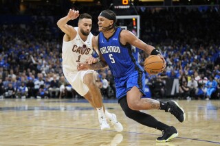 Orlando Magic forward Paolo Banchero (5) drives past Cleveland Cavaliers guard Max Strus (1) during the second half of Game 6 of an NBA basketball first-round playoff series, Friday, May 3, 2024, in Orlando, Fla. (Ǻ Photo/John Raoux)