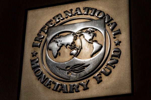 FILE - The logo of the International Monetary Fund is visible on its building, April 5, 2021, in Washington. Pakistan and the International Monetary Fund reached a preliminary agreement for the release of $1.1 billion from a $3 billion bailout following dayslong talks in Islamabad, the IMF said Wednesday, March 20, 2024. (AP Photo/Andrew Harnik, File)