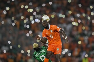 Ivory Coast 's Seko Fofana, top, duels for the ball with Nigeria's Victor Osimhen during the African Cup of Nations final soccer match between Nigeria and Ivory Coast, at the Olympic Stadium of Ebimpe in Abidjan, Ivory Coast, Sunday, Feb. 11, 2024. (APPhoto/Sunday Alamba)