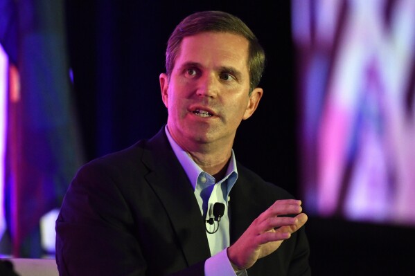 FILE - Kentucky Gov. Andy Beshear responds to a question from the moderator during the Gubernatorial Forum at the 2023 Kentucky Chamber of Commerce annual meeting dinner in Louisville, Ky., Wednesday, Sept. 20, 2023. A snack food manufacturer intends to pump $137 million into a production facility in Kentucky, amounting to the largest economic development project in decades in an area of Louisville that was long overlooked for major investments, Gov. Beshear said Tuesday, Oct. 17. (AP Photo/Timothy D. Easley, File)