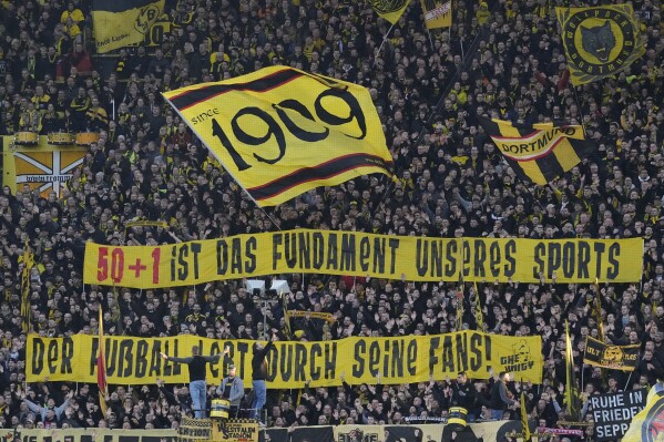 Dortmund supporters display banners before the German Bundesliga soccer match between Borussia Dortmund and TSG Hoffenheim in Dortmund, Germany, Sunday, Feb. 25, 2024. (AP Photo/Martin Meissner)