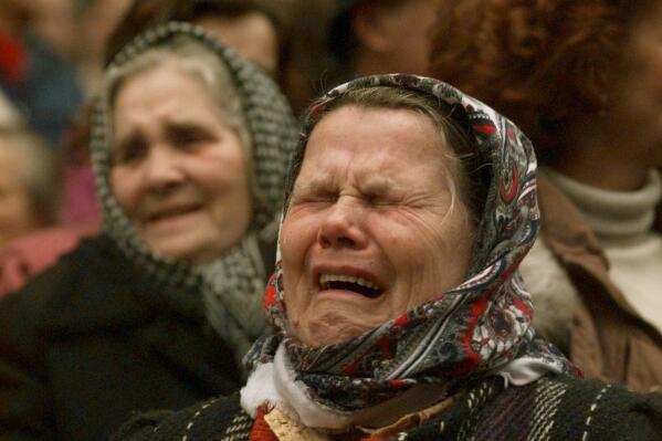 FILE - Bosnian Muslim women weep during a downtown Sarajevo rally calling for unity with their former neighbors in the Serb held neighborhood of Grbavica, on Dec. 11, 1995. Former award-winning Associated Press photographer John Gaps III, who documented everything from war zones to the NCAA College World Series during his career, was found dead at his home Monday, Oct. 17, 2022, in Des Moines, Iowa, his family confirmed Tuesday. He was 63. (AP Photo/John Gaps III, File)