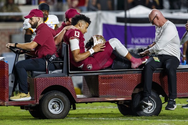 Florida State quarterback Jordan Travis is taken off the field after being injured during the first half of the team's NCAA college football game against North Alabama, Saturday, Nov. 18, 2023, in Tallahassee, Fla. (AP Photo/Colin Hackley)
