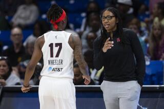 Atlanta Dream head coach Tanisha Wright works during a WNBA